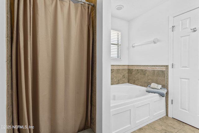 bathroom featuring tile patterned flooring and a bath