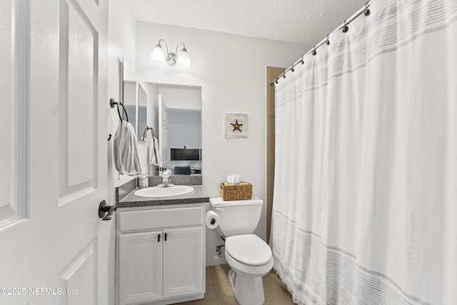 full bathroom with a textured ceiling, curtained shower, tile patterned floors, vanity, and toilet