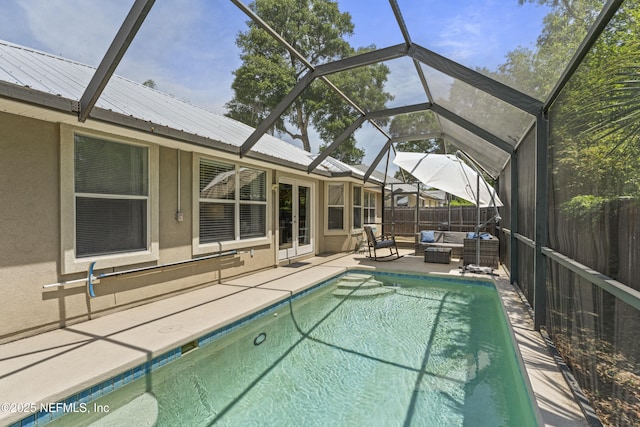 view of pool featuring fence, a fenced in pool, an outdoor living space, a patio area, and glass enclosure