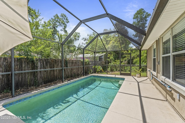 view of swimming pool featuring a fenced backyard, a fenced in pool, a patio, and a lanai