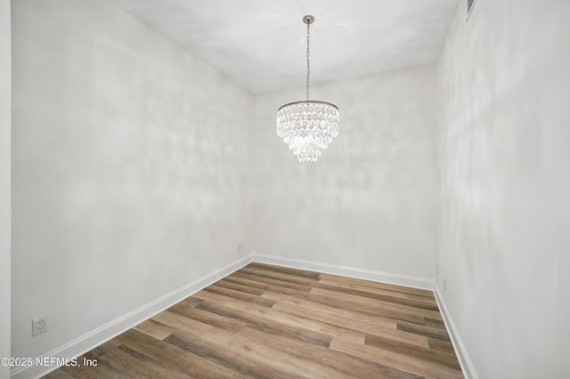 1431 Riverplace Blvd Unit 2003, Jacksonville, FL 32207 - unfurnished dining area with baseboards, visible vents, wood finished floors, and a notable chandelier