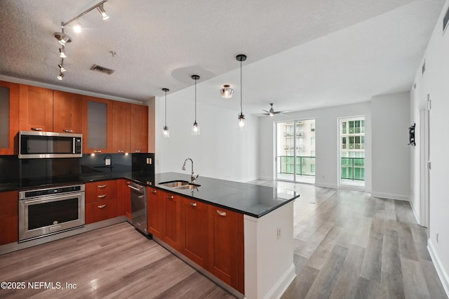 1431 Riverplace Blvd Unit 2003, Jacksonville, FL 32207 - kitchen with appliances with stainless steel finishes, rail lighting, light wood finished floors, and a sink