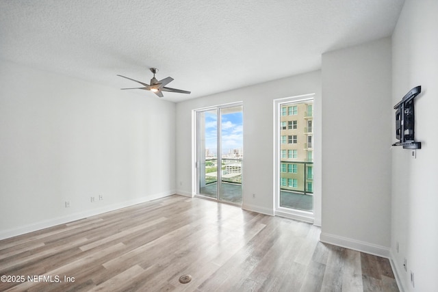 1431 Riverplace Blvd Unit 2003, Jacksonville, FL 32207 - spare room with wood finished floors, ceiling fan, a textured ceiling, and baseboards