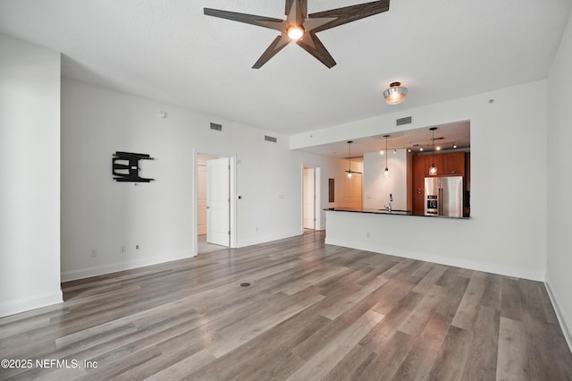 1431 Riverplace Blvd Unit 2003, Jacksonville, FL 32207 - unfurnished living room featuring visible vents, ceiling fan, light wood-style flooring, and baseboards