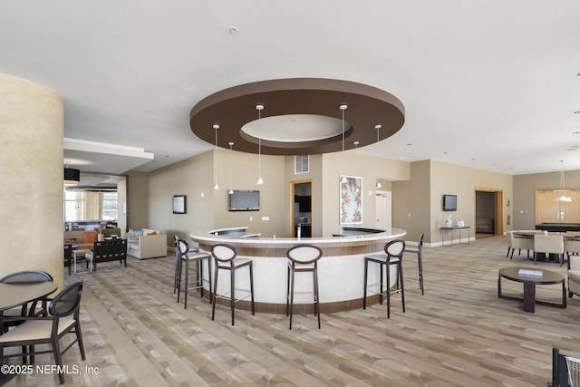 1431 Riverplace Blvd Unit 2003, Jacksonville, FL 32207 - kitchen with light wood-style flooring, a breakfast bar, visible vents, baseboards, and hanging light fixtures