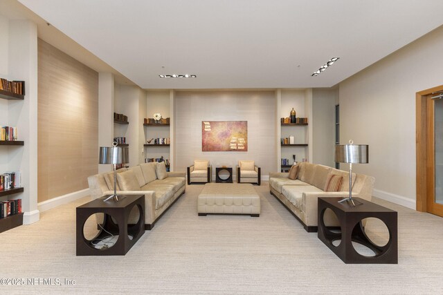 1431 Riverplace Blvd Unit 2003, Jacksonville, FL 32207 - living area featuring baseboards, built in shelves, and light carpet