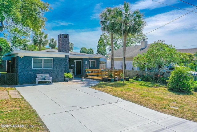 573 Oleander St, Neptune Beach, FL 32266 - ranch-style house featuring a chimney, stone siding, and a deck