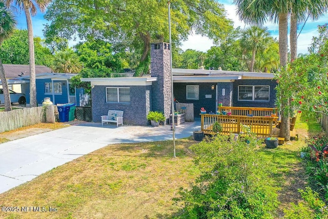 573 Oleander St, Neptune Beach, FL 32266 - rear view of house with a chimney
