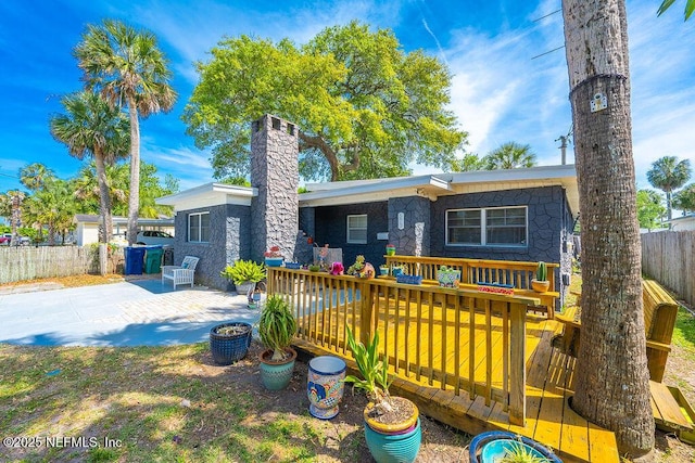 573 Oleander St, Neptune Beach, FL 32266 - view of front of home with fence, a chimney, a deck, and a patio
