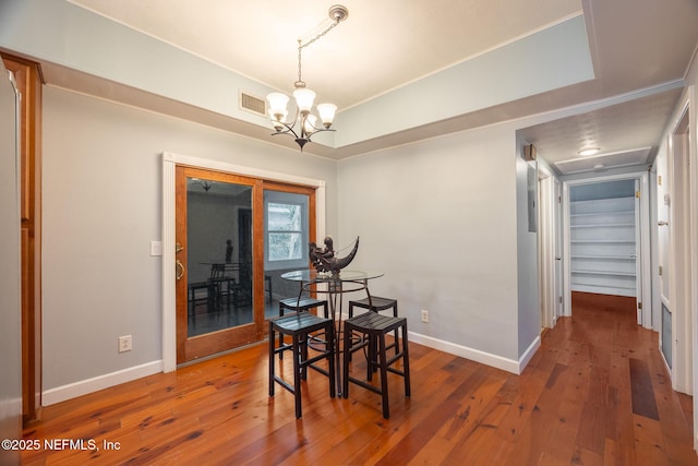 573 Oleander St, Neptune Beach, FL 32266 - dining space with a chandelier, hardwood / wood-style flooring, and baseboards