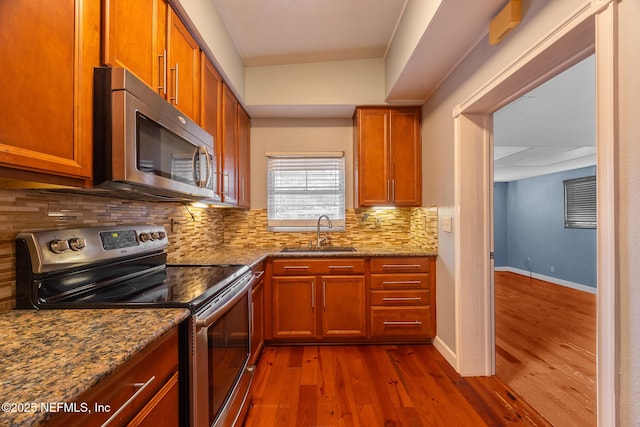 573 Oleander St, Neptune Beach, FL 32266 - kitchen with appliances with stainless steel finishes, a sink, dark wood finished floors, backsplash, and dark stone countertops