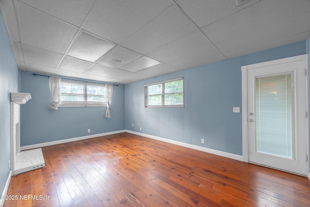 573 Oleander St, Neptune Beach, FL 32266 - unfurnished room featuring hardwood / wood-style floors, baseboards, and a drop ceiling