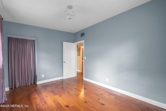573 Oleander St, Neptune Beach, FL 32266 - unfurnished bedroom featuring baseboards and hardwood / wood-style flooring