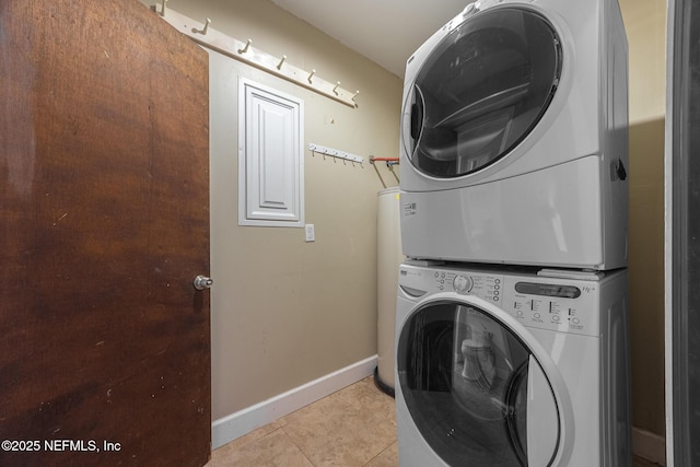 573 Oleander St, Neptune Beach, FL 32266 - washroom with stacked washing machine and dryer, baseboards, and light tile patterned flooring