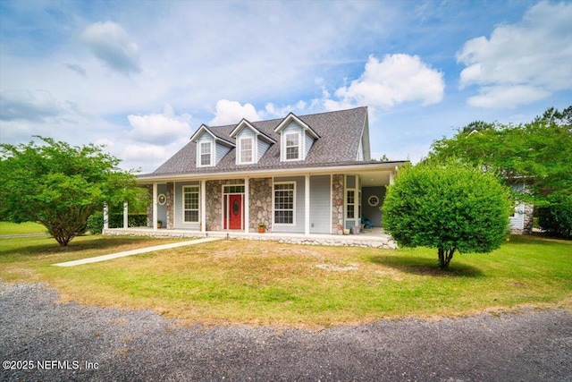 view of front of property with a front lawn, stone siding, and covered porch