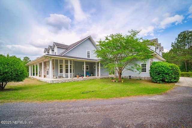 country-style home with covered porch and a front yard