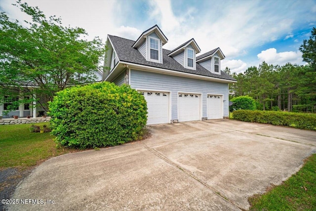 view of side of property with driveway, a yard, and a shingled roof