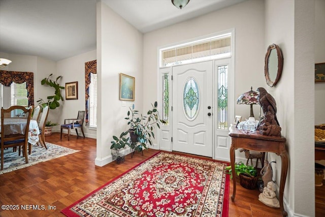 foyer featuring a wealth of natural light, wood finished floors, and baseboards