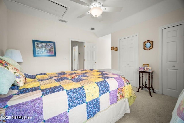 carpeted bedroom featuring attic access, a ceiling fan, and visible vents