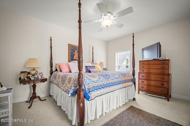 bedroom featuring ceiling fan, baseboards, and light carpet