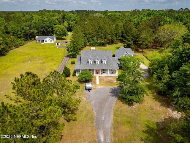 birds eye view of property with a forest view