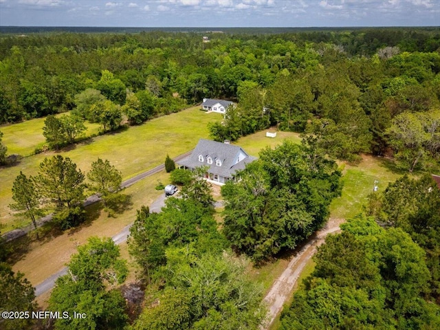 drone / aerial view featuring a wooded view