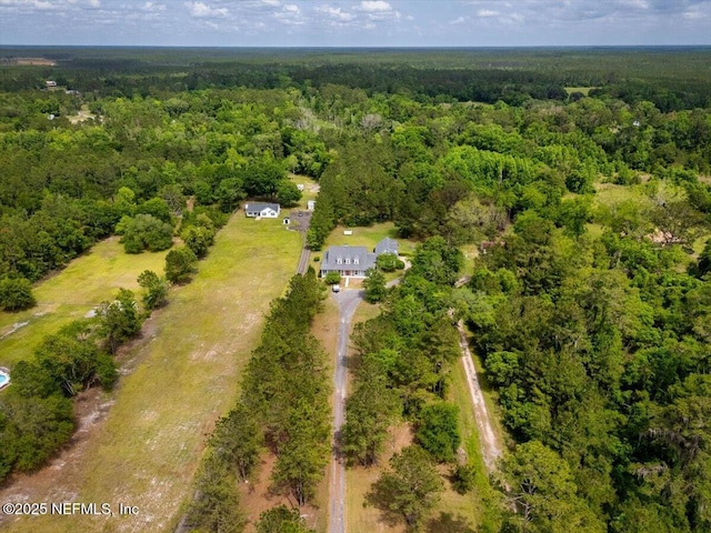 aerial view featuring a wooded view