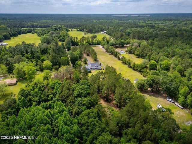 birds eye view of property with a view of trees