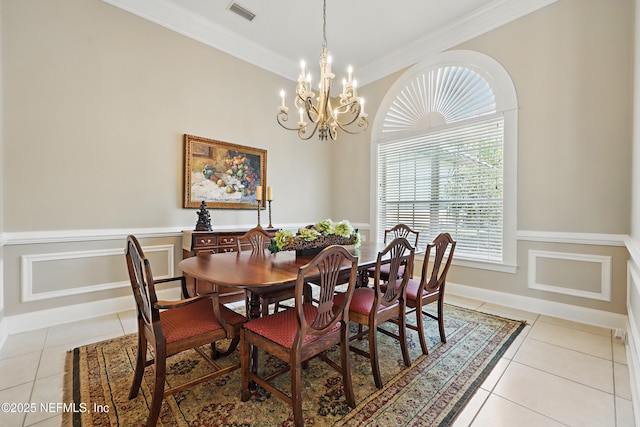 dining room featuring light tile patterned flooring, visible vents, crown molding, and a notable chandelier