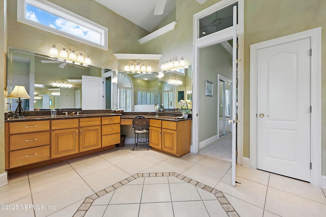 bathroom featuring plenty of natural light, a ceiling fan, high vaulted ceiling, and tile patterned flooring