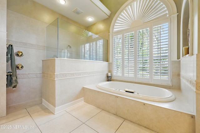 full bathroom with visible vents, walk in shower, tile walls, a garden tub, and tile patterned flooring