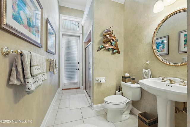 bathroom with a shower stall, toilet, baseboards, ornamental molding, and tile patterned flooring