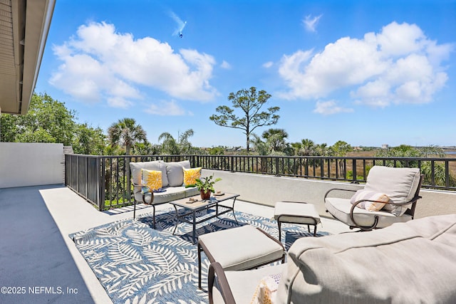 view of patio featuring a balcony and an outdoor living space