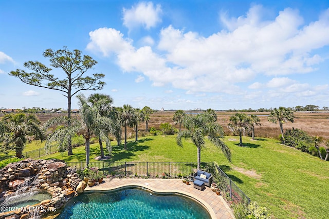 view of pool with a lawn, a rural view, a fenced in pool, and a fenced backyard
