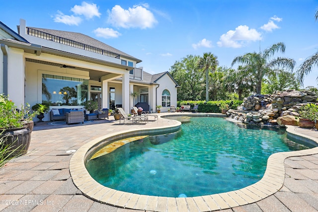 pool featuring an outdoor hangout area, ceiling fan, and a patio area