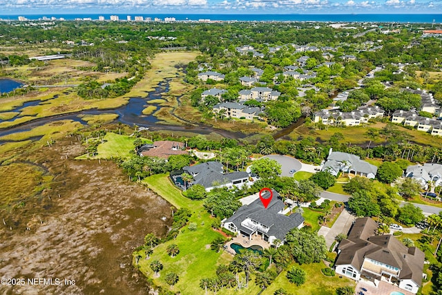 drone / aerial view featuring a residential view and a water view