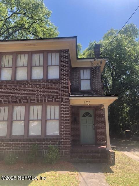 view of front of home featuring brick siding