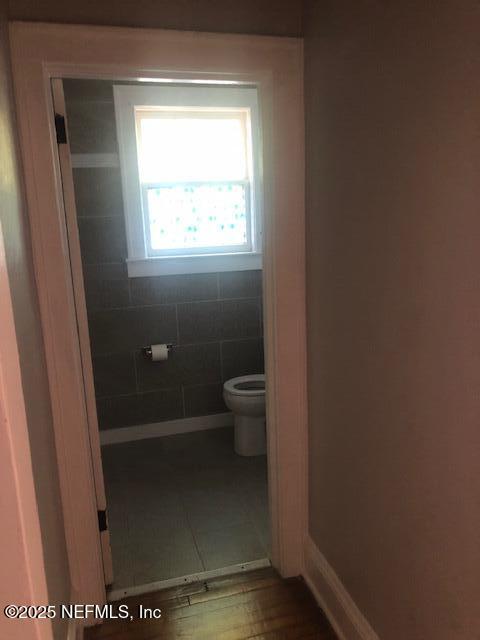 bathroom with toilet and baseboards