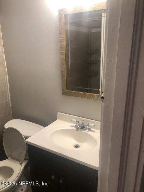 bathroom featuring toilet and vanity