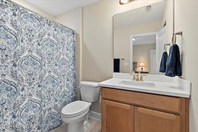 bathroom featuring visible vents, vanity, toilet, a shower with shower curtain, and tile patterned floors