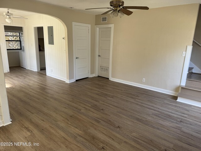 interior space featuring a ceiling fan, visible vents, stairs, and arched walkways