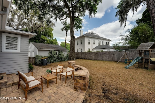 view of yard featuring a fenced backyard, a patio area, and a playground