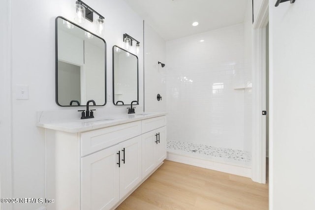5817 Silver Sands Cir, Keystone Heights, FL 32656 - full bath with wood finished floors, a sink, double vanity, and tiled shower
