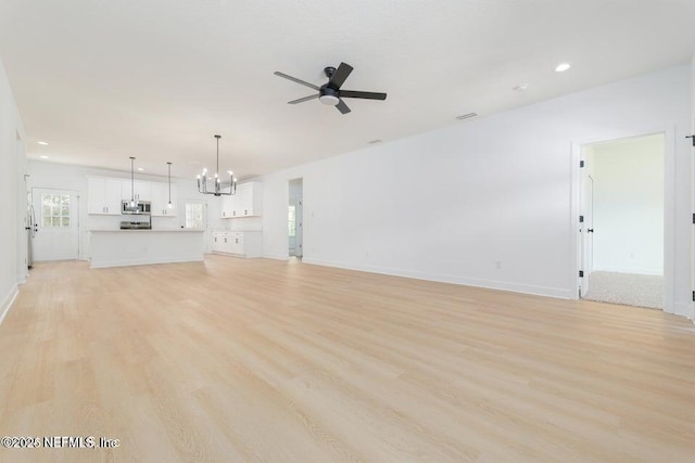 5817 Silver Sands Cir, Keystone Heights, FL 32656 - unfurnished living room with recessed lighting, light wood-style flooring, baseboards, and ceiling fan with notable chandelier