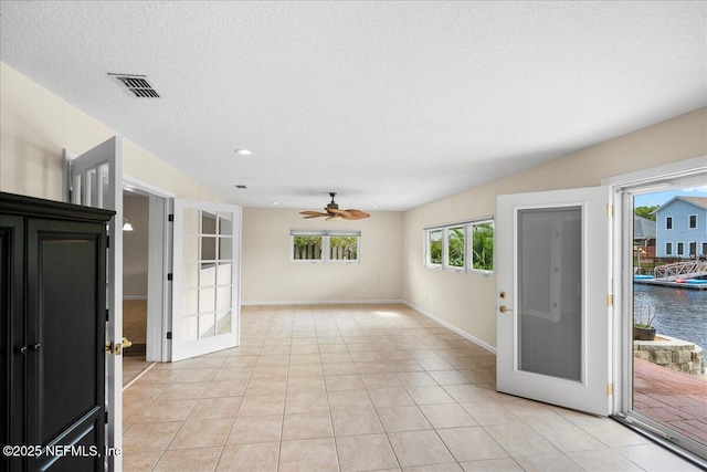 4201 San Pablo Rd S, Jacksonville, FL 32224 - empty room with a textured ceiling, a ceiling fan, baseboards, light tile patterned floors, and visible vents