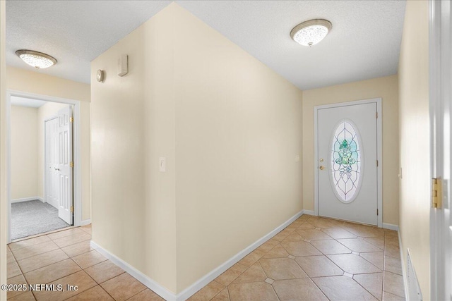 4201 San Pablo Rd S, Jacksonville, FL 32224 - entryway featuring baseboards, a textured ceiling, and light tile patterned floors