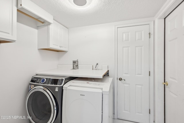 116 Lost Beach Ln, Ponte Vedra Beach, FL 32082 - laundry area with cabinet space, separate washer and dryer, and a textured ceiling