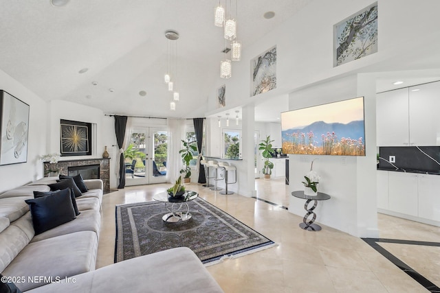 116 Lost Beach Ln, Ponte Vedra Beach, FL 32082 - living room featuring a glass covered fireplace, a high ceiling, french doors, and recessed lighting