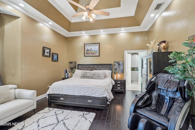 116 Lost Beach Ln, Ponte Vedra Beach, FL 32082 - bedroom with crown molding, baseboards, ensuite bathroom, dark wood-type flooring, and a tray ceiling