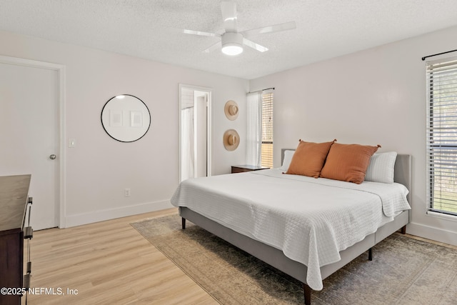 1625 Panther Ridge Ct, Jacksonville, FL 32225 - bedroom featuring a textured ceiling, ceiling fan, light wood finished floors, and baseboards
